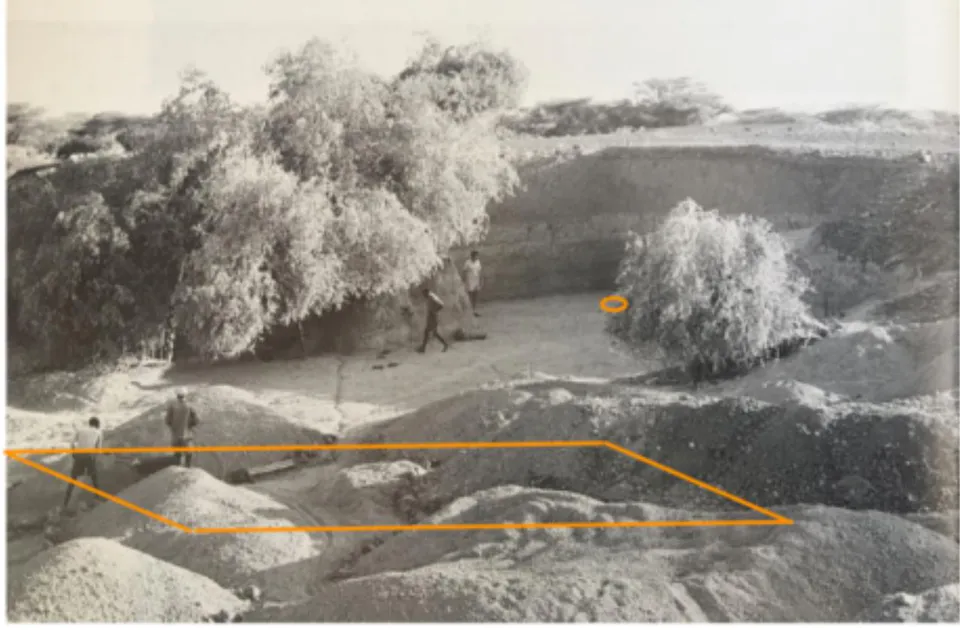 Fig. 9: The piles of rock from excavations in 1986 cover the area where the bones of the skeleton were found in 1984. (Photograph from 7, p.148b), with orange annotations added.